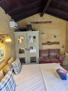a bedroom with a large bed and a couch at Le petit Olivier 