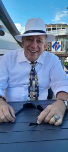 a man wearing a hat and a shirt and tie at appartement Villa Morgane in Saint-Pierre