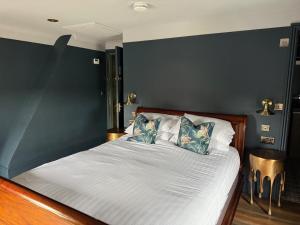 a bedroom with a bed with a blue accent wall at The Old Posthouse in Scalby