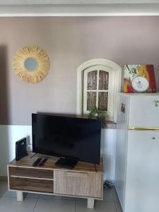 a flat screen tv sitting on top of a table at appartement Villa Morgane in Saint-Pierre