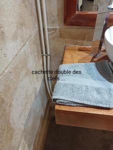 a bathroom with a sink and a blue towel on a counter at appartement Villa Morgane in Saint-Pierre