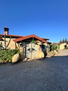 a building with a gate in front of a house at Le petit Olivier 