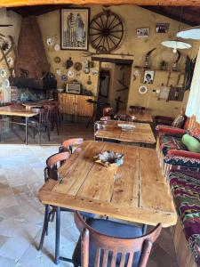 a wooden table and chairs in a room at Le petit Olivier 