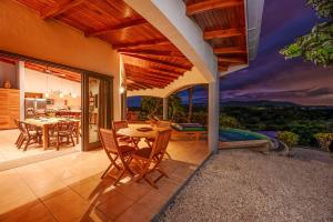 a house with a patio with a table and chairs at Vista Oceano in Playa Hermosa