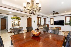 a dining room and living room with a wooden table at Sol Y Mar 4c in Playa Hermosa