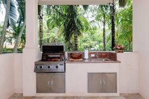 an outdoor kitchen with a stove and a sink at Sol Y Mar 4c in Playa Hermosa