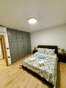 a bedroom with a bed with two dishes on it at VERORE aprtm in Chalkida
