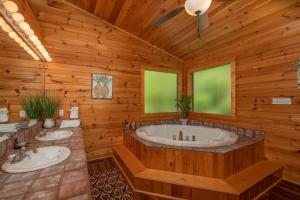 a wooden bathroom with two sinks and a tub at Hawks Heart Lodge by American Patriot Getaways in Shady Grove +24 photos