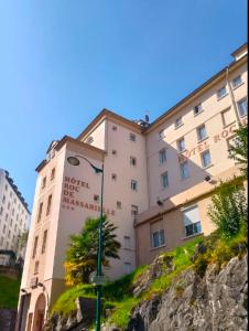 a building with a street light in front of it at Hôtel Roc de Massabielle in Lourdes