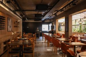 a dining room with wooden tables and chairs at BOOK A FLAT Alameda Lorena Jardins in São Paulo