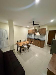 a kitchen and dining room with a table and chairs at Heres Haut Residency in Cochin +60 photos