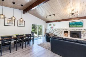 a dining room and living room with a fireplace at Dimple Dell Whole Mountain Setting, Near Trails! in Sandy