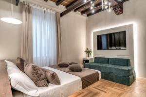 a bedroom with a large bed and a green couch at Madonna del Pantheon in Rome