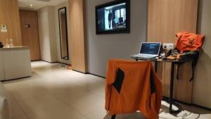 a room with a table with a laptop on it at apartemen alhanafi in Talang Kelapa