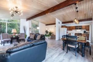 a living room with a couch and a table at Dimple Dell Whole Mountain Setting, Near Trails! in Sandy