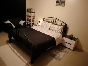 a bedroom with a bed with a black bed frame and pillows at Sterling homes in Eldoret Airport