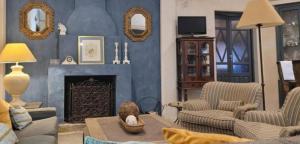 a living room with a couch and a fireplace at El Garrotal de Medina in Carmona