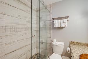 a bathroom with a toilet and a glass shower at 'Bear Crossing Chalet:' Beech Mountain Family Home in Beech Mountain +29 photos