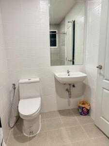 a bathroom with a toilet and a sink at Vela Nakhon Si Thammarat in Nakhon Si Thammarat +34 photos