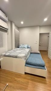 a bedroom with a large bed with a blue mattress at Vela Nakhon Si Thammarat in Nakhon Si Thammarat
