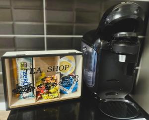 a coffee maker sitting next to a box of food at Amy Mountain Stay in Cristian