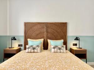 a bedroom with a large bed with two lamps at Loving Los Abrigos in Los Abrigos