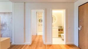 a room with white walls and a bathroom with a toilet at Luxury Flats with Pool in Quarteira by LovelyStay in Quarteira