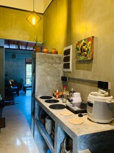 a kitchen with a counter with a stove top at Summer Waves Villa in Ahangama