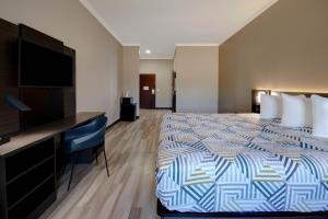a hotel room with a bed and a flat screen tv at Motel Worth, TX in Fort Worth
