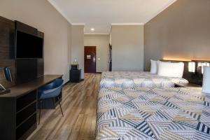 a hotel room with a bed and a flat screen tv at Motel Worth, TX in Fort Worth