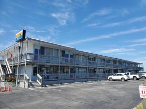 a building with a parking lot in front of it at The Breezeway Motel & Resturant in Topsail Beach