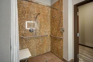 a shower in a bathroom with a tile wall at Motel Worth, TX in Fort Worth