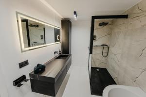 a bathroom with a sink and a toilet and a mirror at Cube 21 in Mons +15 photos