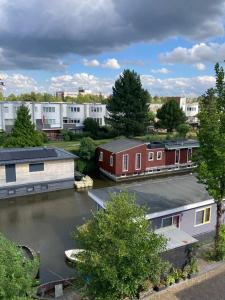 arial view of a river with houses and buildings at Cessinas in Groningen