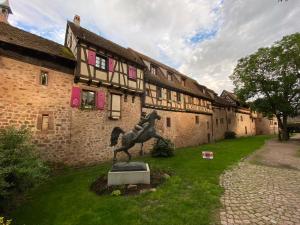 a statue of a horse in front of a building at Les Authentics - La Maison d'Amélie in Riquewihr