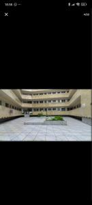 a large building with a courtyard in front of it at Praiamongagua in Mongaguá