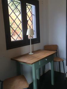 a table with a lamp in a room with a window at Terrasse Maisonnette Chambre jardin in Rufisque +43 photos