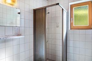 a shower with a glass door in a bathroom at A Nett’s Nest - Haus in Gerlosberg +33 photos