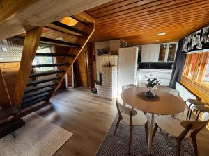 a dining room with a table and a staircase at Villa Vanttaja in Kuusamo