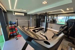 a gym with treadmills and ellipticals in a room at Cobertura em Hotel de Luxo na Beira Mar in Natal