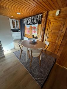 a dining room with a table and chairs at Villa Vanttaja in Kuusamo +22 photos
