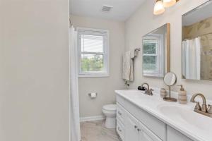 a white bathroom with a sink and a toilet at Master Classic-18 Mi To Augusta National Golf in Kennelworth +24 photos
