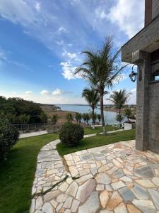 a stone walkway with a view of the ocean at Castelo do Lago Hotel e Restaurante in Fama