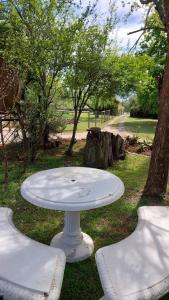 a white table sitting in the grass in a park at Acorns and Quackers Self Catering in Underberg