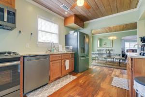 a kitchen with stainless steel appliances and a dining room at 4 Mi to Jetty Park Beach! Family Home with Game Room in Fort Pierce