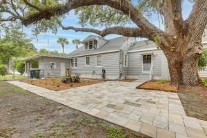 a house with a tree and a driveway at 4 Mi to Jetty Park Beach! Family Home with Game Room in Fort Pierce
