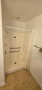 a bathroom with a shower with a shower curtain at Country Inn Marion in Marion