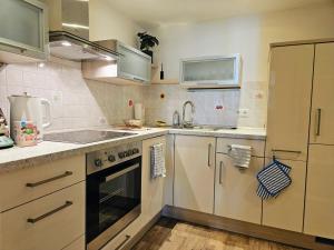 a kitchen with a sink and a stove top oven at Chic 2-room apartment in the historic cathedral district in Augsburg