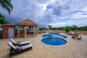 a patio with a swimming pool and a gazebo at Tuscany Sunville in Montego Bay