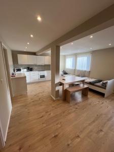 un grand salon avec une table et une cuisine dans l'établissement Miami Monteur Apartment, à Rodenbach